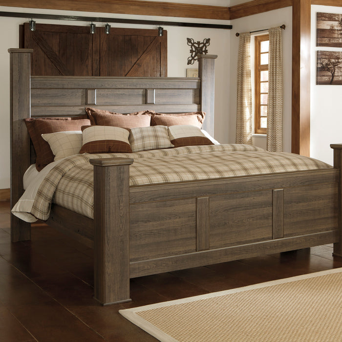 Wooden bed with plaid bedding in a bedroom setting