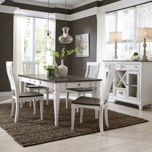 A white dining room set with a rectangular table and four matching chairs, styled in a modern dining room with dark gray walls, a brown shag rug, and pendant lights.