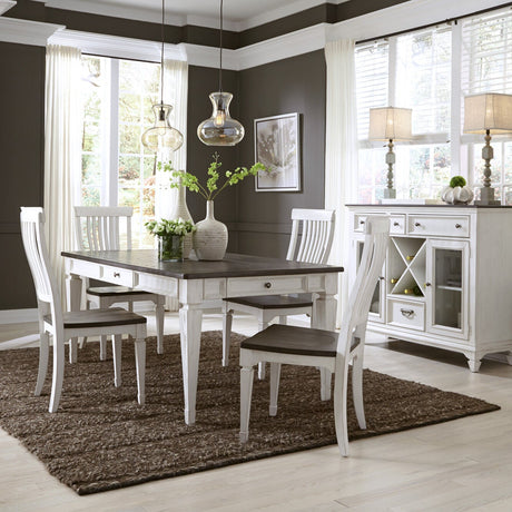 A white dining room set with a rectangular table and four matching chairs, styled in a modern dining room with dark gray walls, a brown shag rug, and pendant lights.